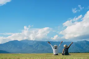 The backs of two men hooray on the grass