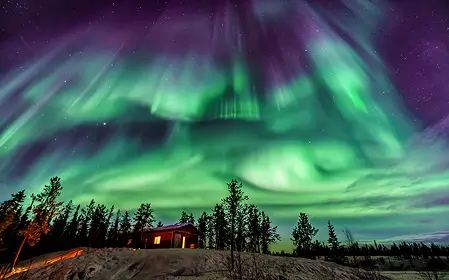 A cottage and aurora