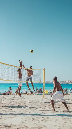 A group of people were playing with a ball in the beach